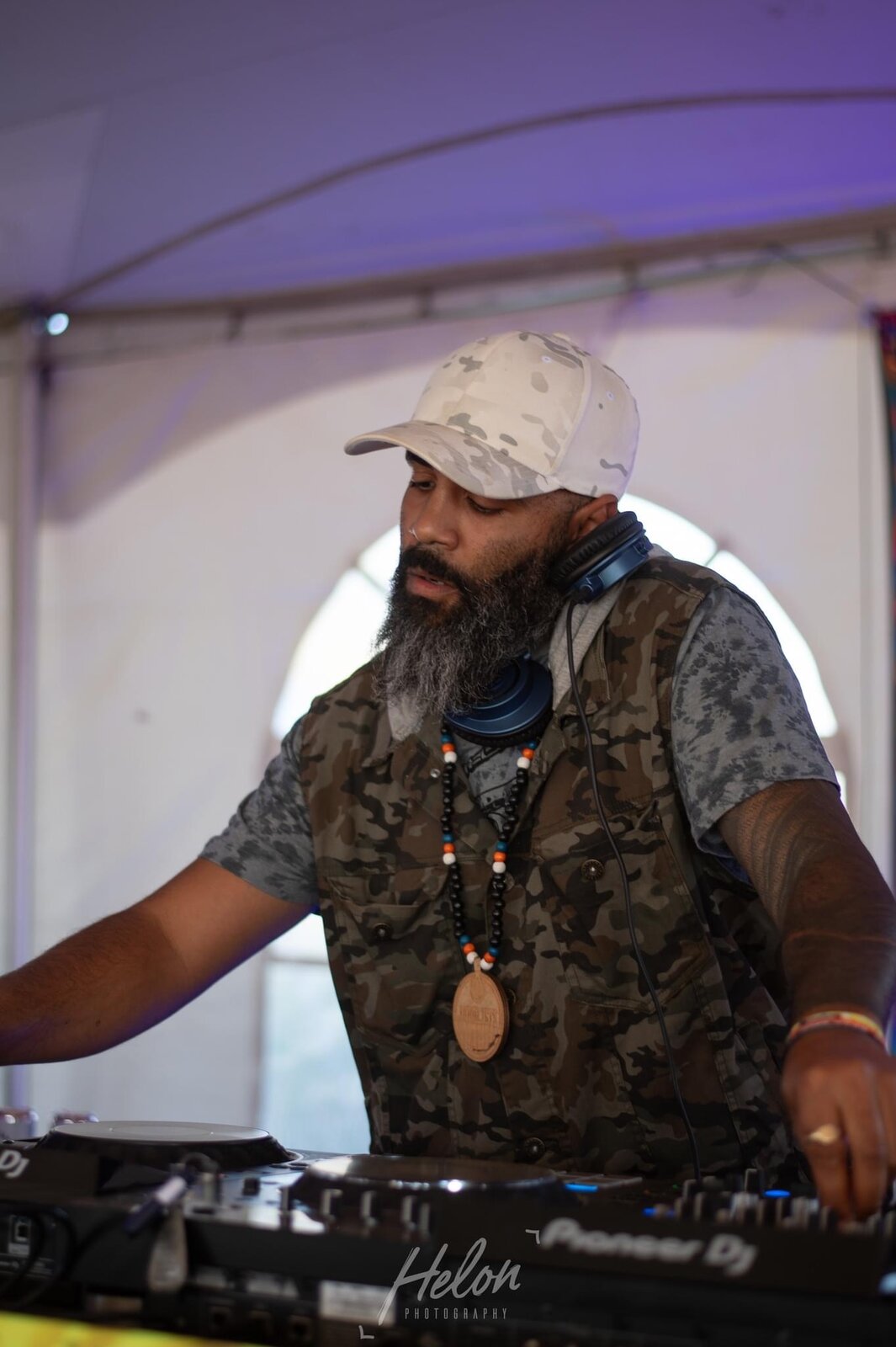 JT.dnb behind the decks under a festival tent
