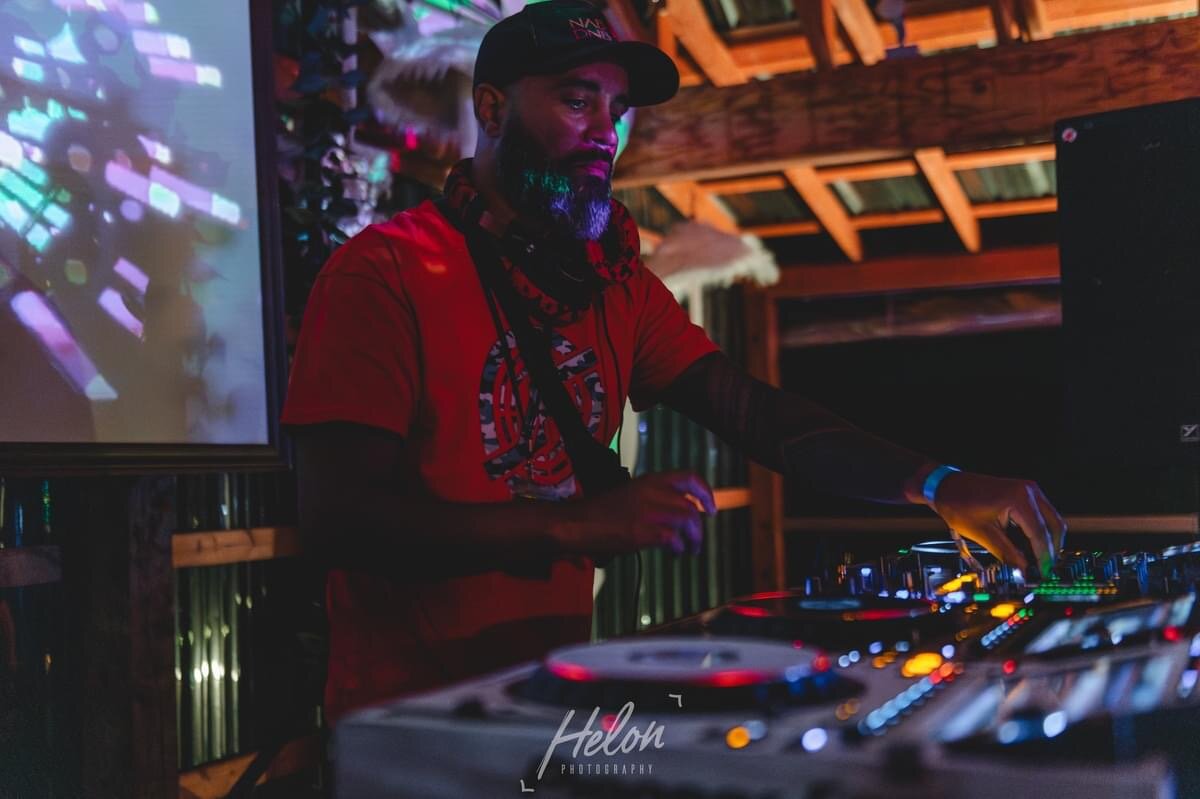 JT.dnb on the decks in a red shirt